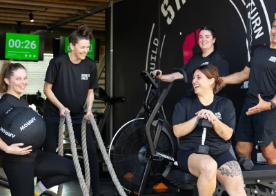 Group image of people smiling inside Shred Shed
